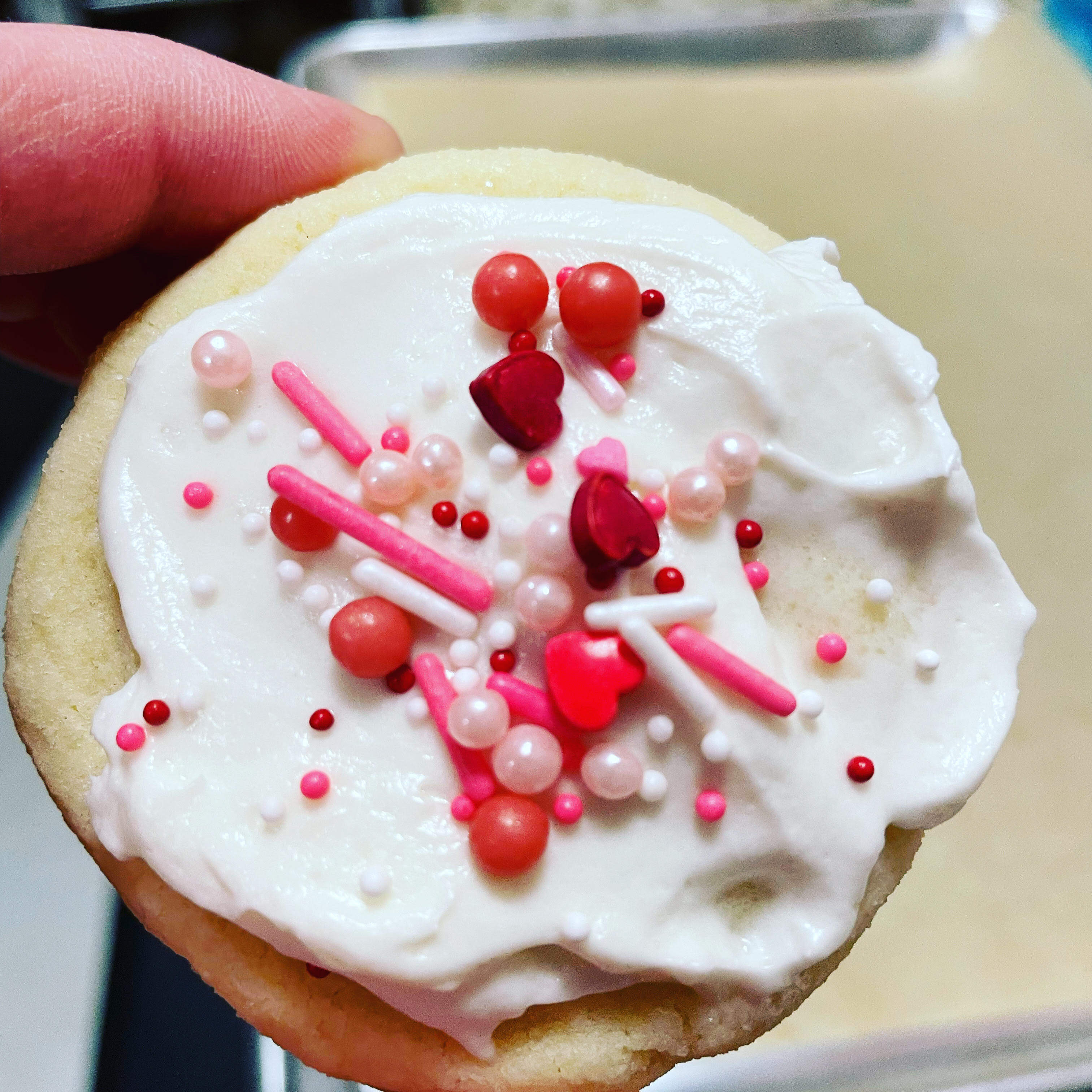 Sugar cookies topped with cream cheese buttercream & Valentine's Day Sprinkles