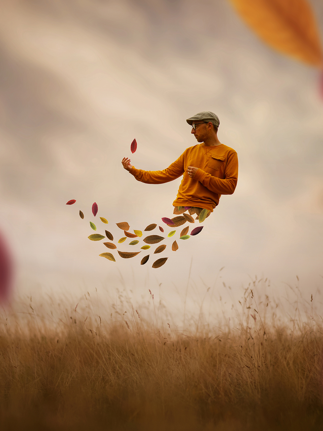 Male subject moves through the air with autumn leaves falling out of his shirt
