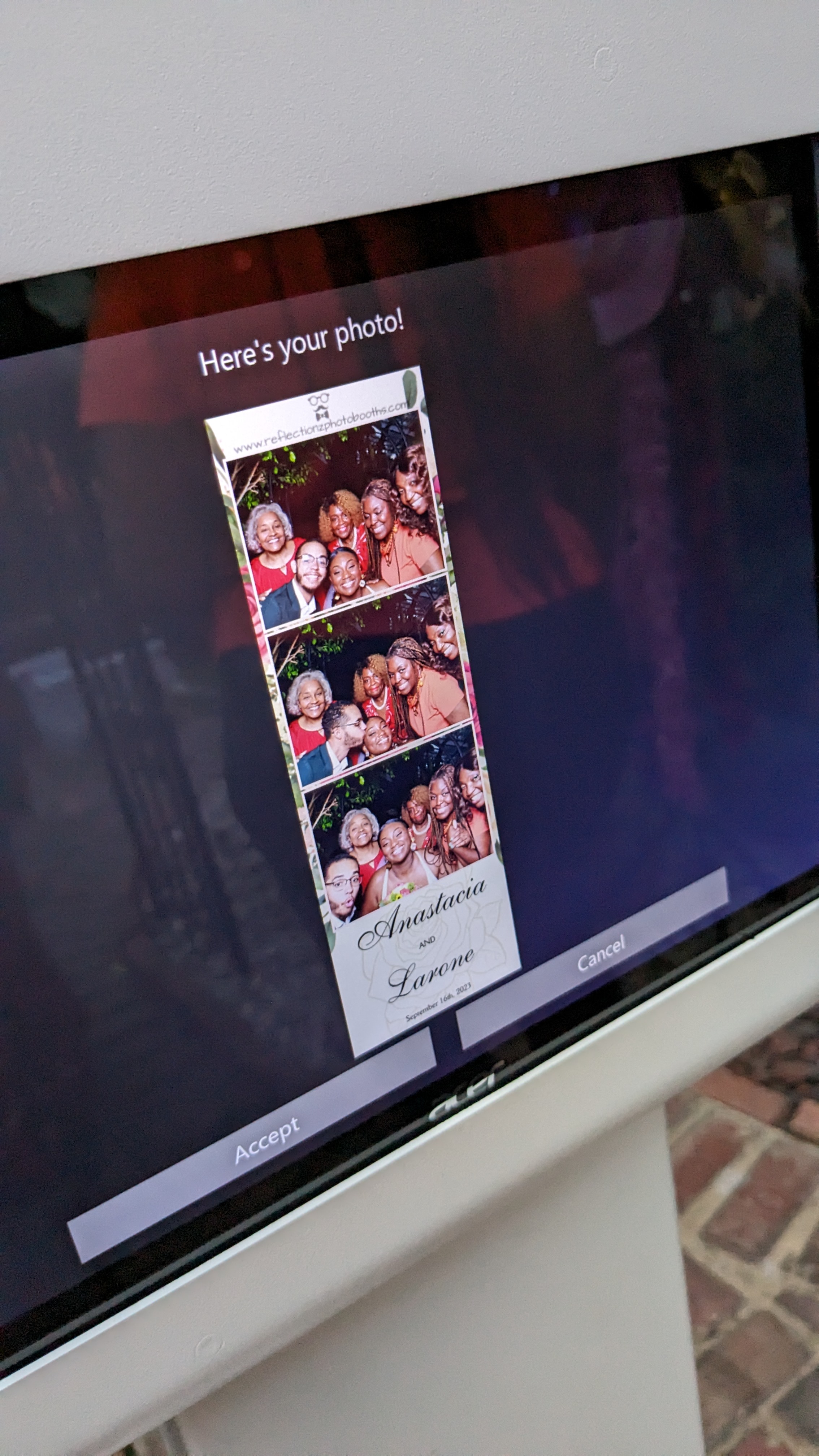 Photo booth screen displaying a preview of a photo strip from an event.